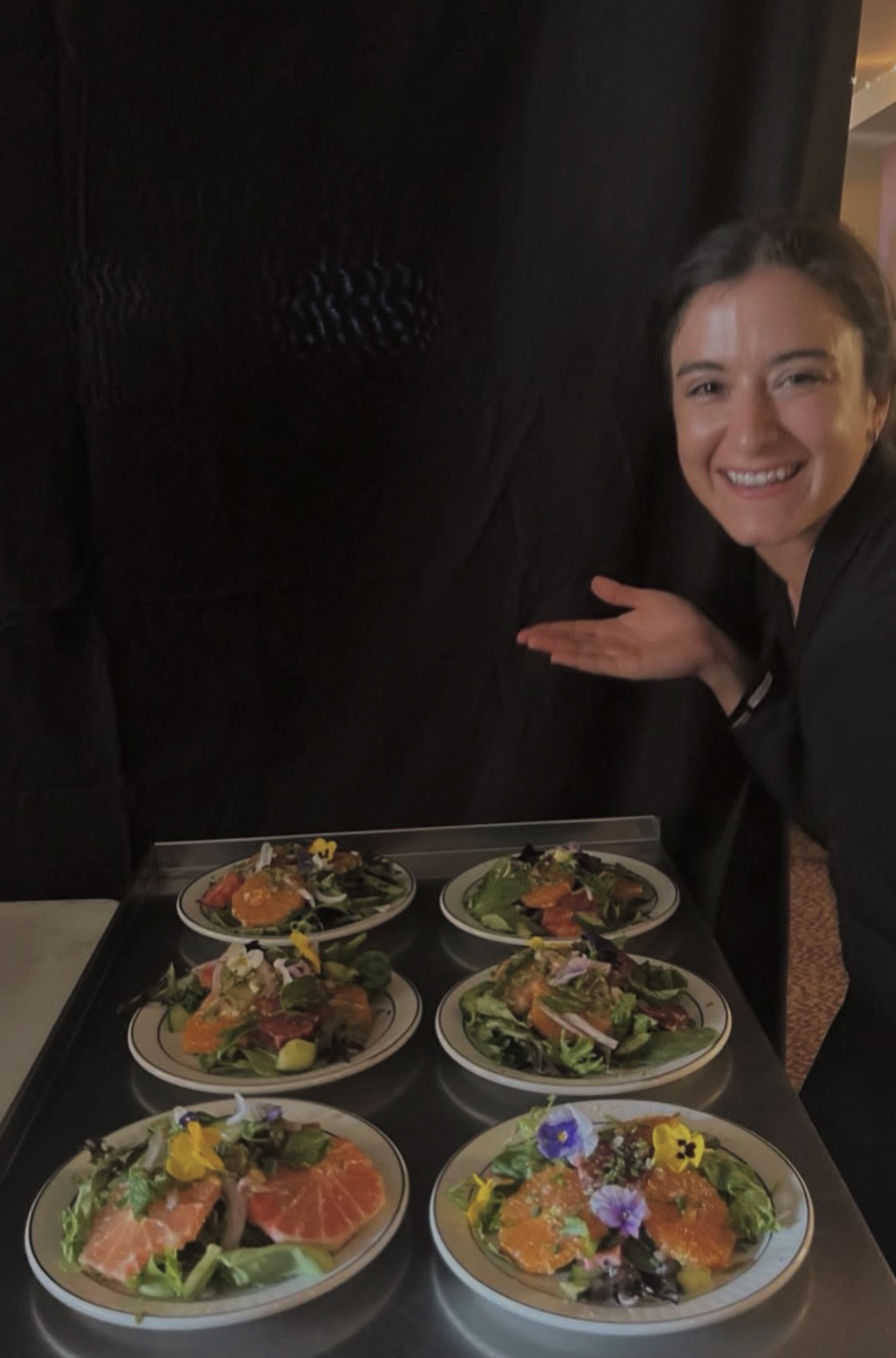 Peyton presenting freshly plated dishes